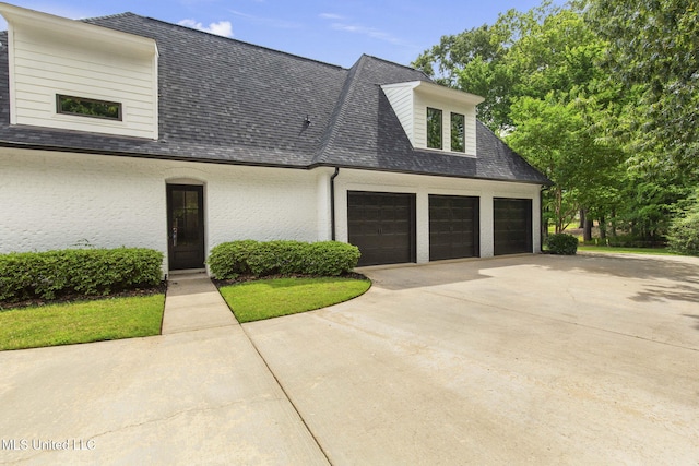 302 Covington Cv, Madison, MS 39110 - view of front of house featuring driveway, a shingled roof, and a garage