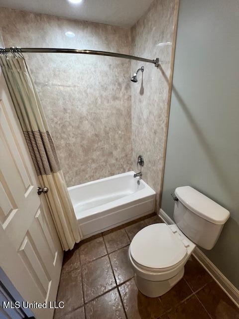 bathroom featuring toilet and shower / bath combo