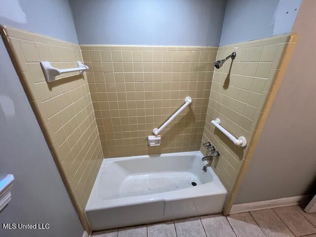 bathroom featuring tile patterned floors and separate shower and tub