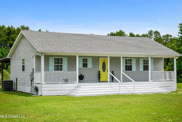 view of front of house featuring a porch, central AC unit, and a front yard