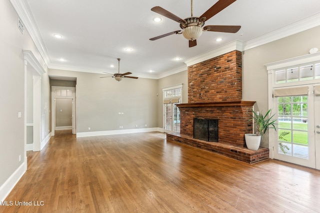 421 Starling Dr, Slidell, LA 70461 - unfurnished living room featuring light wood finished floors, a brick fireplace, ornamental molding, and a ceiling fan