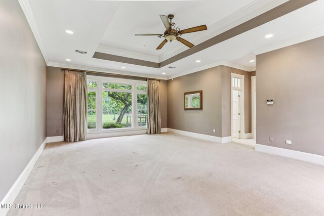 421 Starling Dr, Slidell, LA 70461 - spare room featuring baseboards, a tray ceiling, a ceiling fan, and light carpet