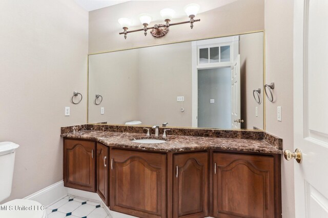 421 Starling Dr, Slidell, LA 70461 - bathroom with baseboards, toilet, and vanity