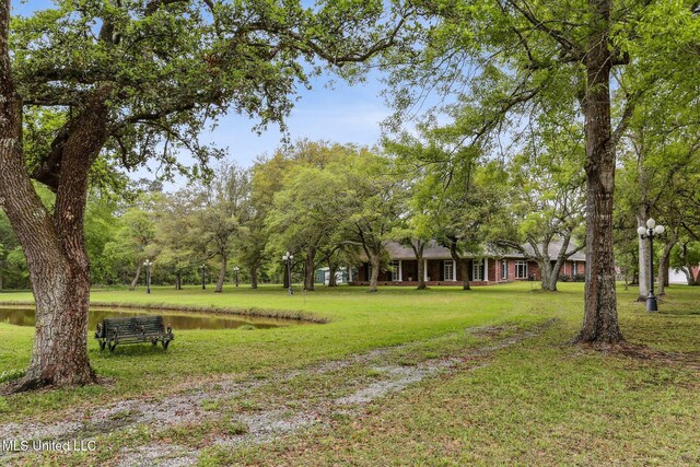 421 Starling Dr, Slidell, LA 70461 - surrounding community with a water view and a yard