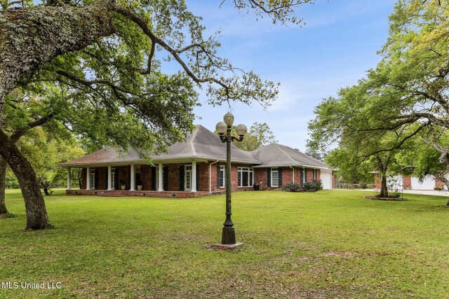 421 Starling Dr, Slidell, LA 70461 - view of front facade with brick siding, a garage, and a front lawn