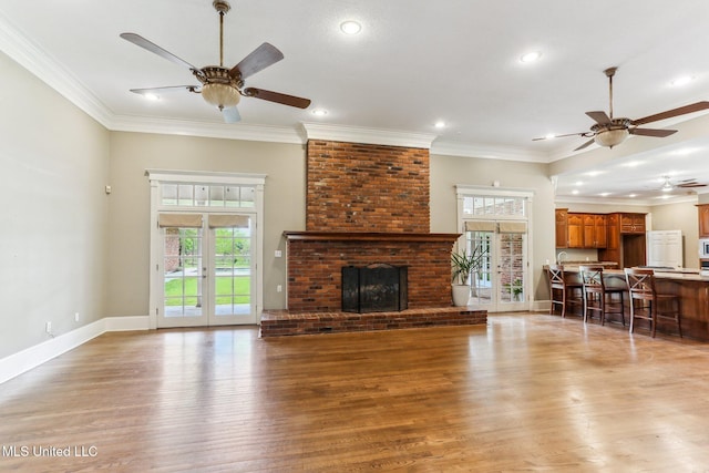 421 Starling Dr, Slidell, LA 70461 - unfurnished living room featuring light wood-type flooring, ceiling fan, and ornamental molding