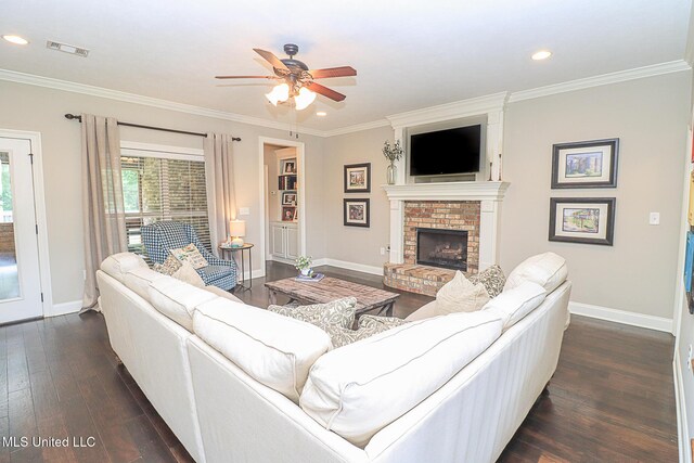 109 Elizabeth Dr, Brandon, MS 39042 - living room with dark wood-type flooring, baseboards, a ceiling fan, ornamental molding, and a fireplace