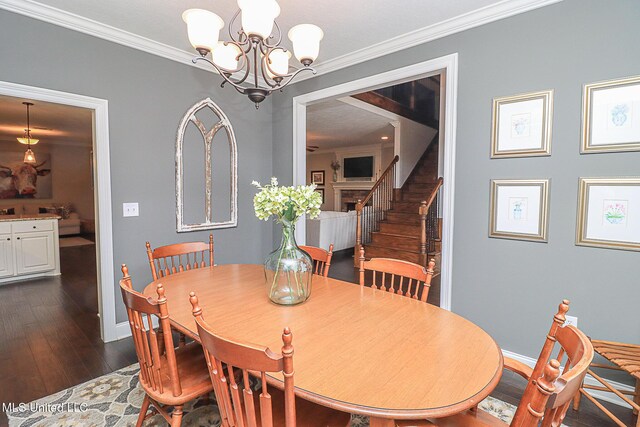 109 Elizabeth Dr, Brandon, MS 39042 - dining area with stairway, baseboards, dark wood-style flooring, a chandelier, and crown molding