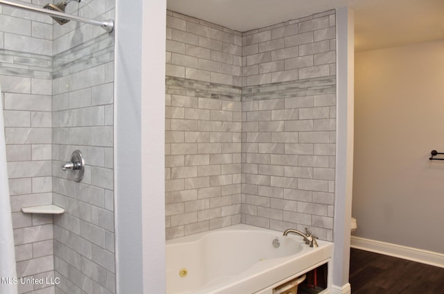 bathroom featuring shower / bath combo with shower curtain, hardwood / wood-style floors, and toilet