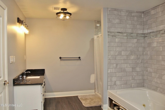 bathroom with vanity, plus walk in shower, and wood-type flooring