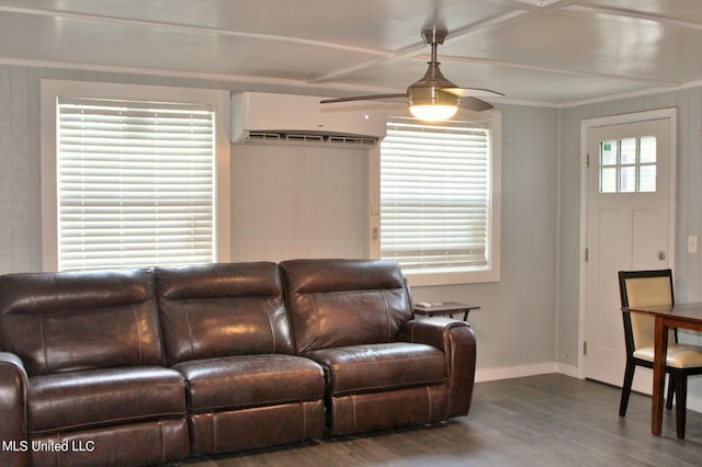 living room with a wall mounted AC, a healthy amount of sunlight, wood-type flooring, and ceiling fan