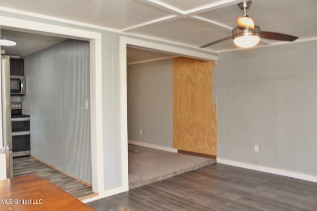 interior space with wooden walls, ceiling fan, and dark hardwood / wood-style flooring