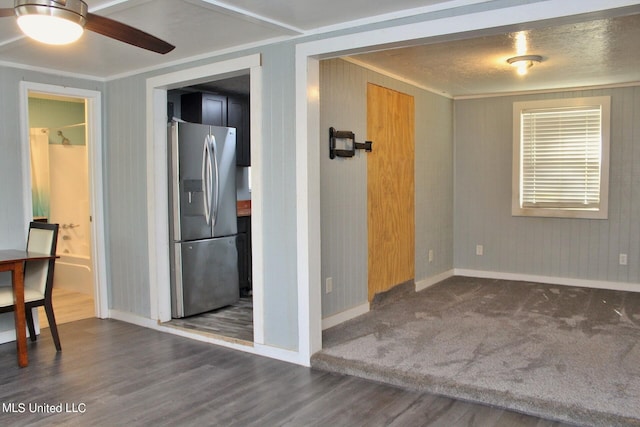 interior space featuring ceiling fan, ornamental molding, and dark hardwood / wood-style floors