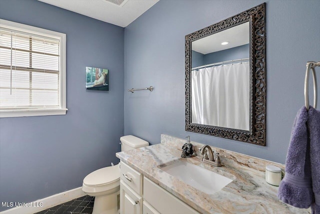 bathroom featuring vanity and toilet