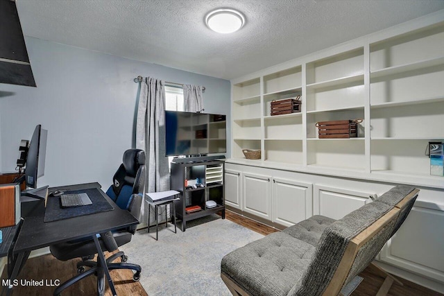 office featuring wood-type flooring and a textured ceiling