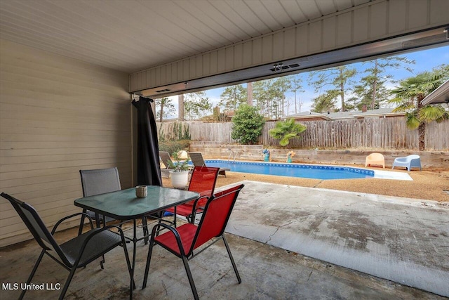 view of patio with a fenced in pool