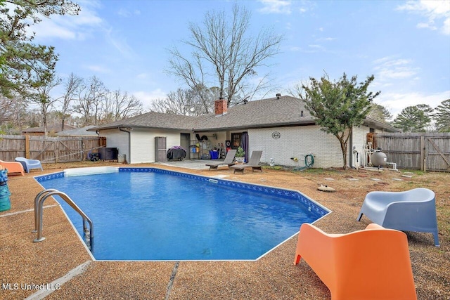 view of swimming pool with area for grilling and a patio area