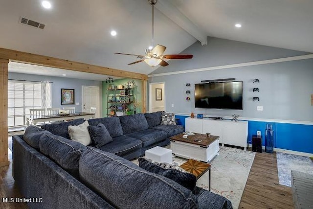 living room featuring hardwood / wood-style flooring, ceiling fan, and lofted ceiling with beams