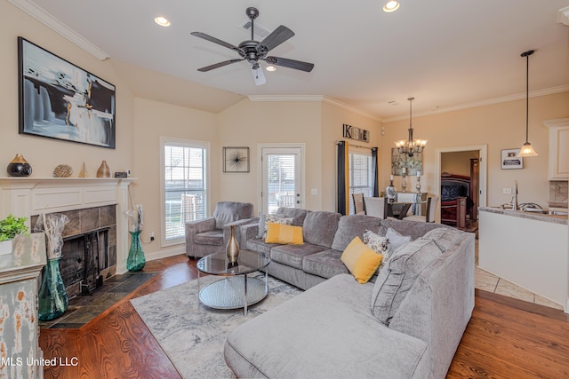 127 Palin Dr, Madison, MS 39110 - living room with wood finished floors, a chandelier, a high end fireplace, a ceiling fan, and crown molding