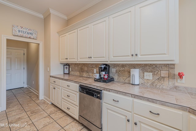 127 Palin Dr, Madison, MS 39110 - kitchen featuring stainless steel dishwasher, decorative backsplash, crown molding, light tile patterned floors, and white cabinetry