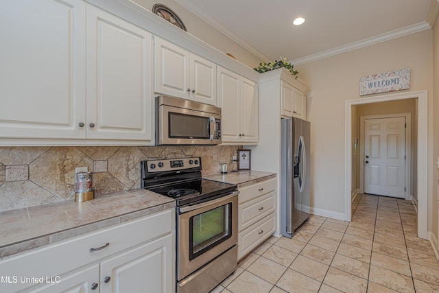 127 Palin Dr, Madison, MS 39110 - kitchen featuring stainless steel appliances, decorative backsplash, crown molding, white cabinetry, and light tile patterned floors