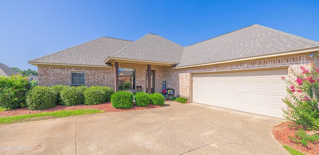 127 Palin Dr, Madison, MS 39110 - view of front facade with concrete driveway, brick siding, roof with shingles, and an attached garage