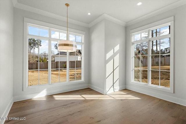 entryway with baseboards, wood finished floors, and ornamental molding