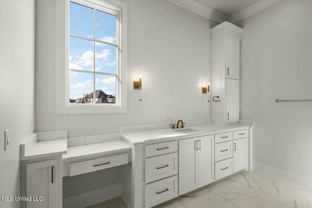 bathroom with marble finish floor, baseboards, and vanity