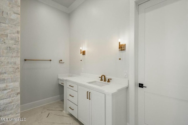 bathroom featuring marble finish floor, baseboards, and vanity