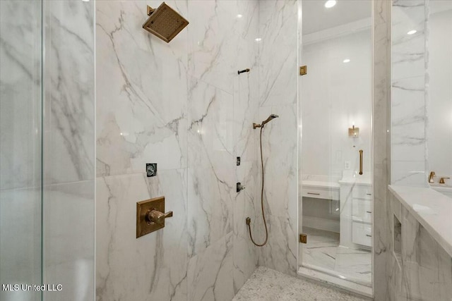 bathroom featuring a marble finish shower and vanity