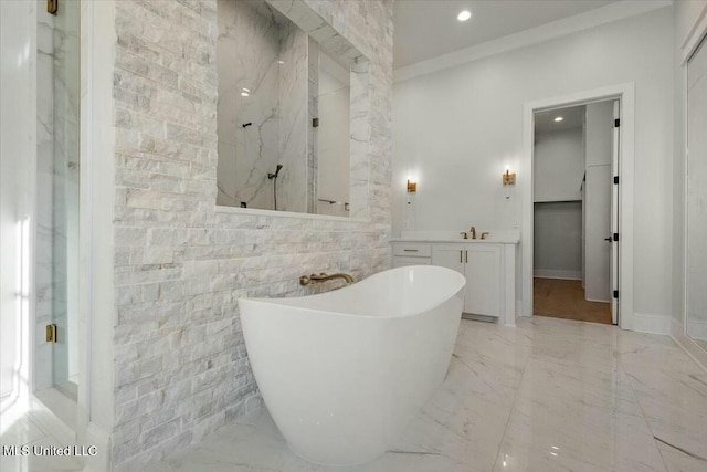 bathroom with marble finish floor, a marble finish shower, recessed lighting, a freestanding bath, and vanity