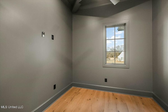 empty room with baseboards and light wood-style floors