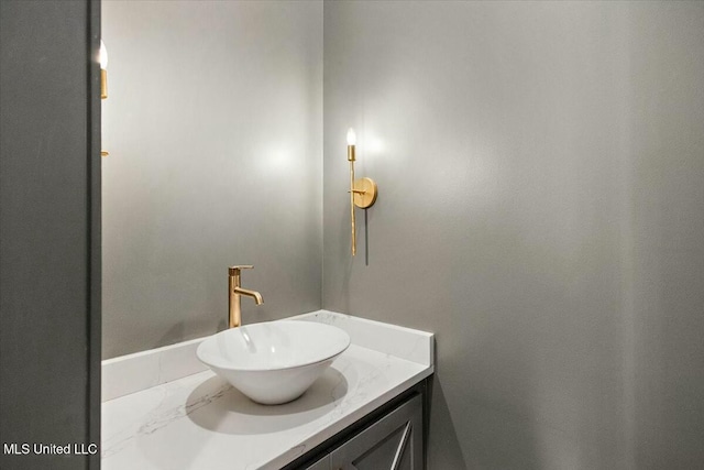 bathroom with marble finish floor and vanity