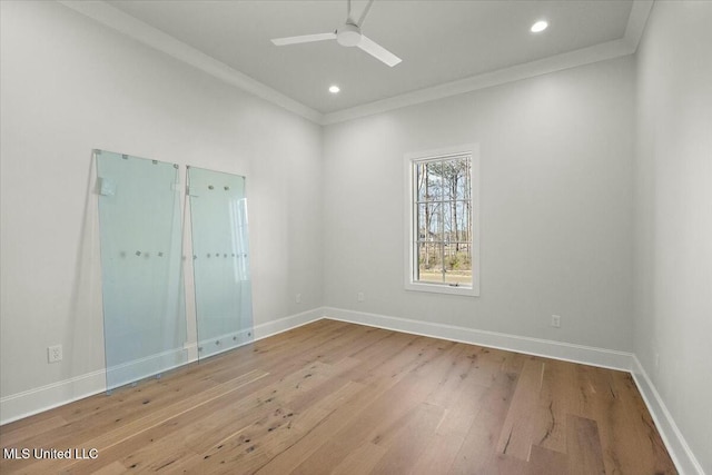 spare room featuring baseboards, ceiling fan, ornamental molding, wood finished floors, and recessed lighting