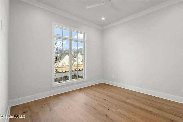 spare room featuring ceiling fan, light wood-style flooring, recessed lighting, baseboards, and ornamental molding