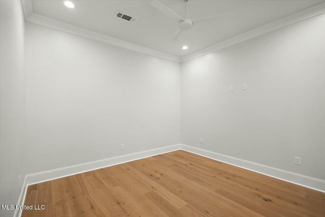 unfurnished room with light wood finished floors, recessed lighting, visible vents, ornamental molding, and baseboards