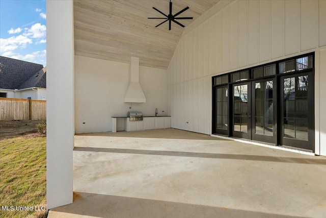 view of patio / terrace with exterior kitchen, fence, area for grilling, and a ceiling fan