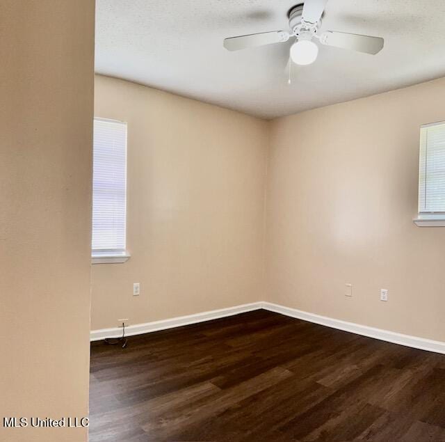 2614 George St, Gulfport, MS 39503 - spare room with dark wood-type flooring, baseboards, and ceiling fan