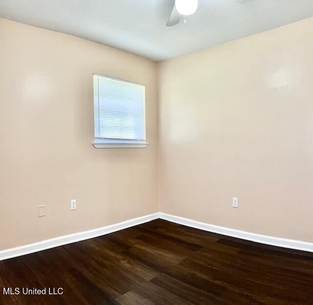 2614 George St, Gulfport, MS 39503 - spare room featuring baseboards, wood finished floors, and a ceiling fan