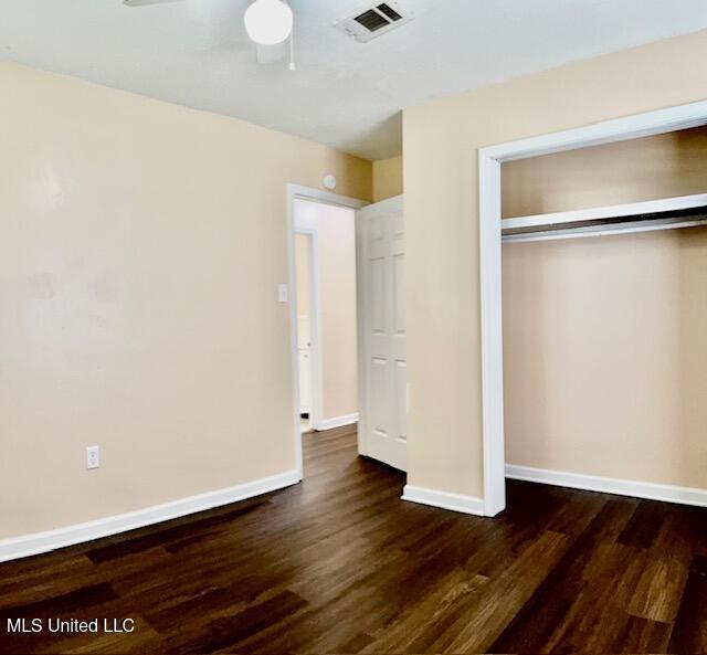 2614 George St, Gulfport, MS 39503 - unfurnished bedroom featuring wood finished floors, baseboards, a closet, and ceiling fan