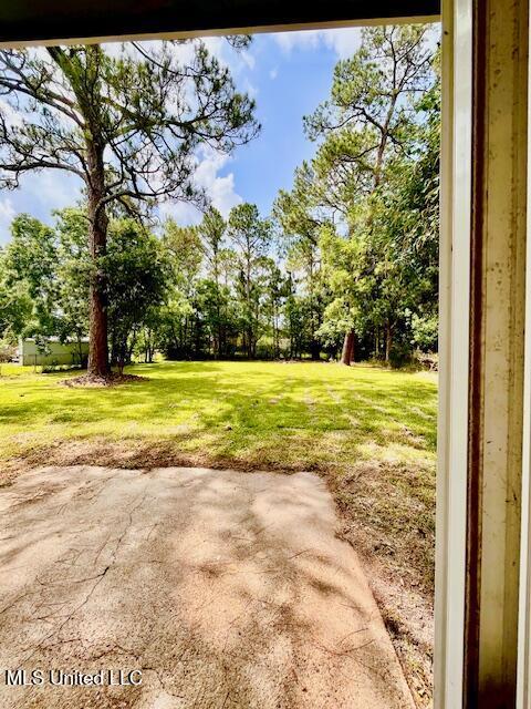 2614 George St, Gulfport, MS 39503 - view of green lawn featuring a patio area and view of scattered trees