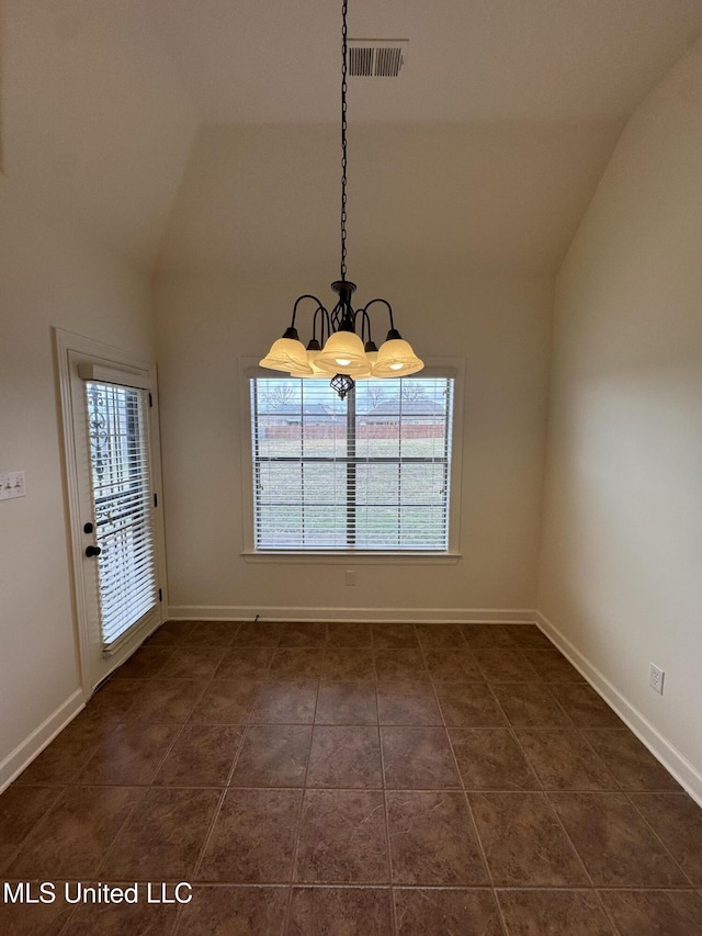 unfurnished dining area featuring lofted ceiling, dark tile patterned flooring, baseboards, and visible vents