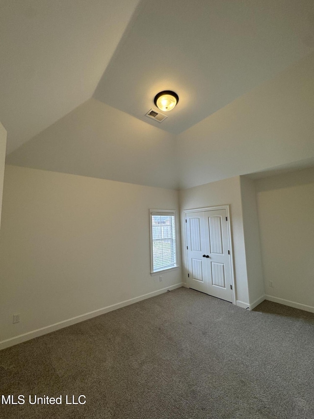 interior space featuring lofted ceiling, baseboards, and visible vents