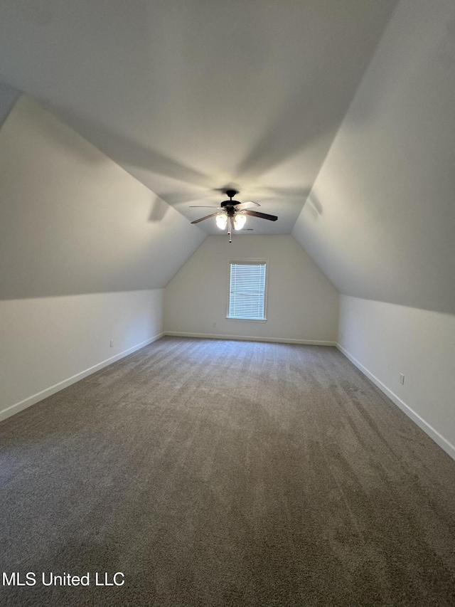 additional living space featuring a ceiling fan, lofted ceiling, baseboards, and carpet floors