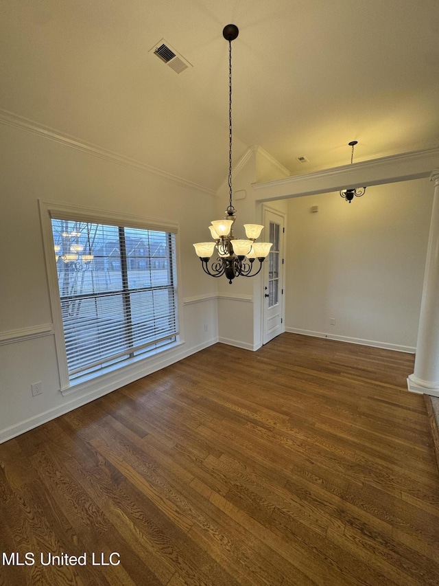 unfurnished dining area with visible vents, dark wood-style floors, crown molding, lofted ceiling, and a chandelier