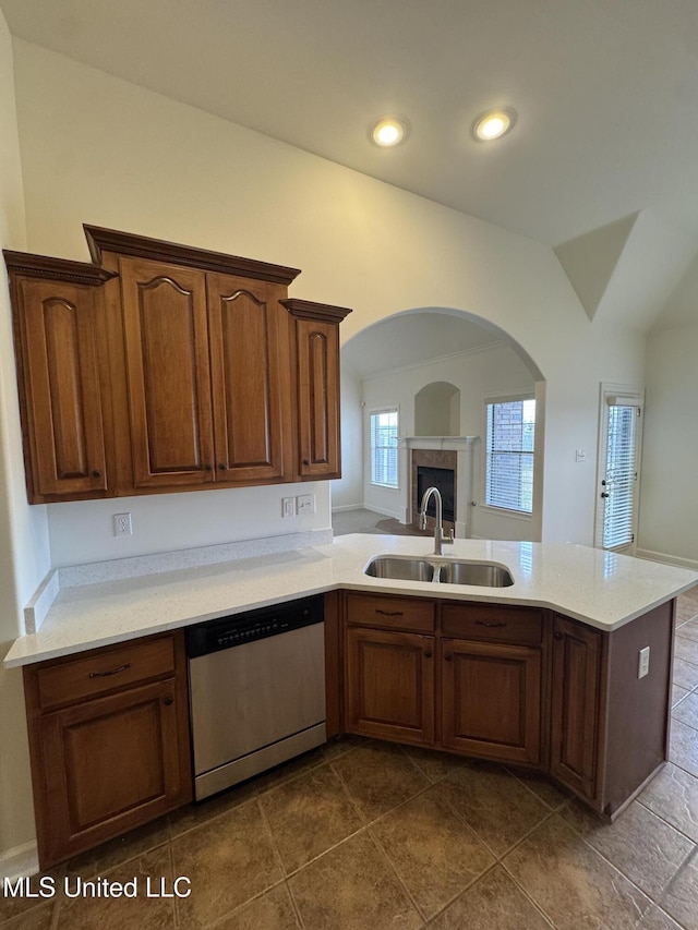 kitchen featuring dishwasher, light countertops, recessed lighting, a peninsula, and a sink