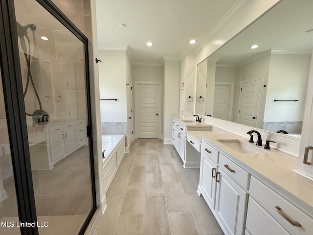 bathroom featuring vanity, crown molding, and separate shower and tub