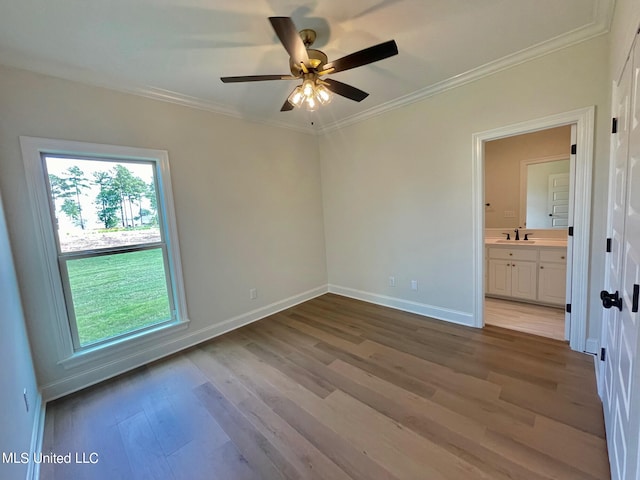 unfurnished room with light hardwood / wood-style floors, ornamental molding, sink, and ceiling fan