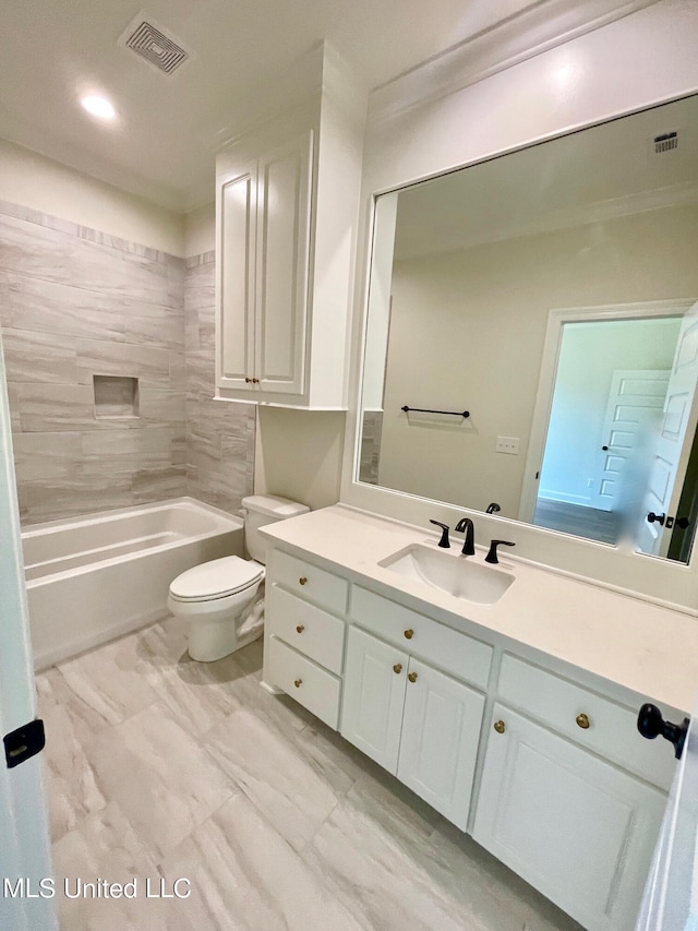 full bathroom featuring vanity, tiled shower / bath combo, and toilet