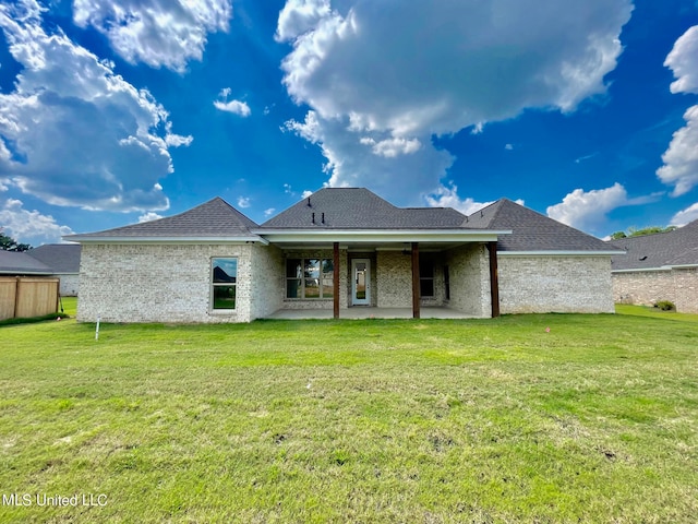 back of house featuring a yard and a patio